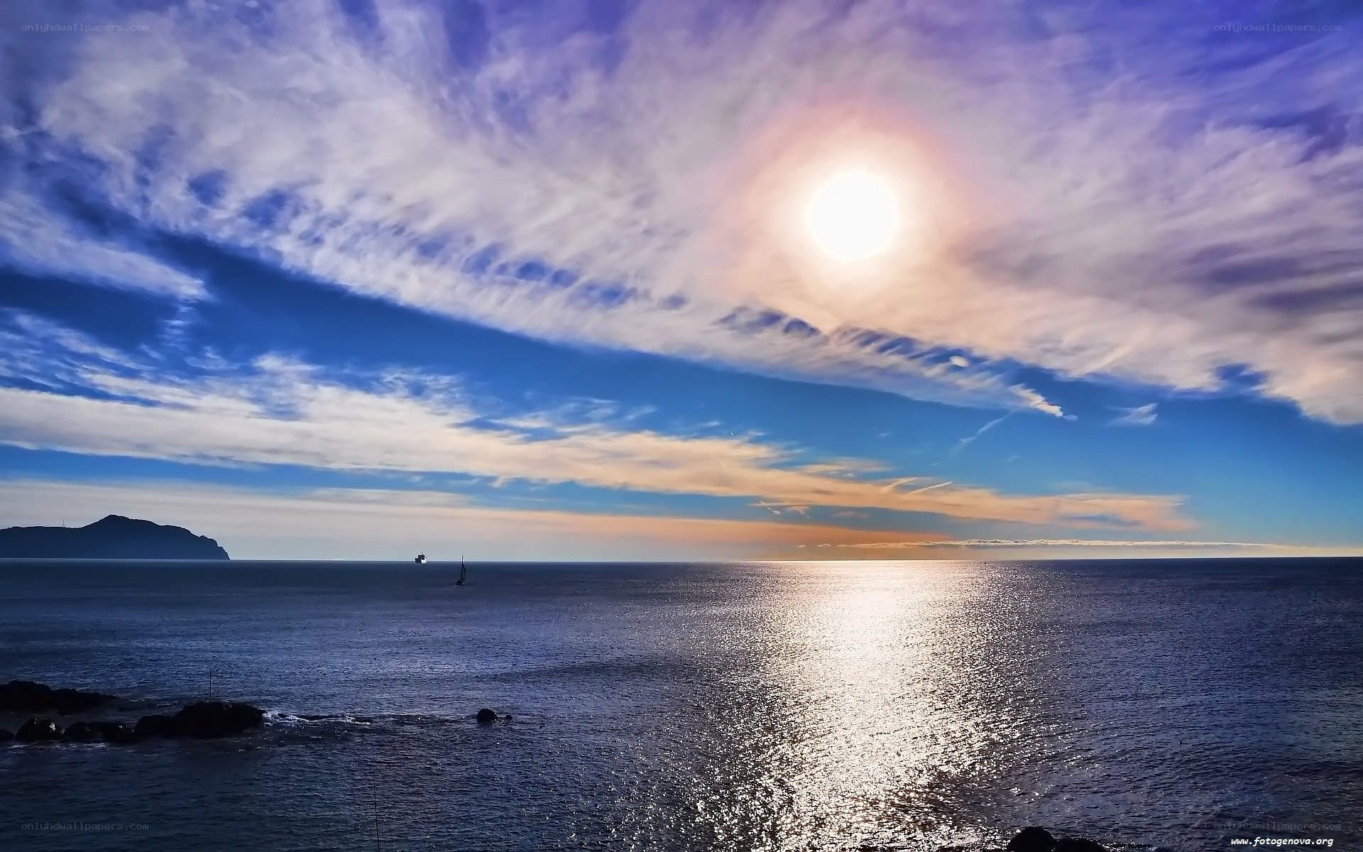 Sunset over the sea with sailboat