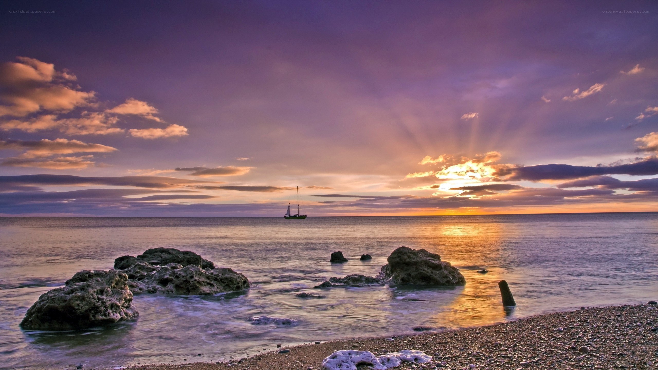 Sunset over the sea with sailboat