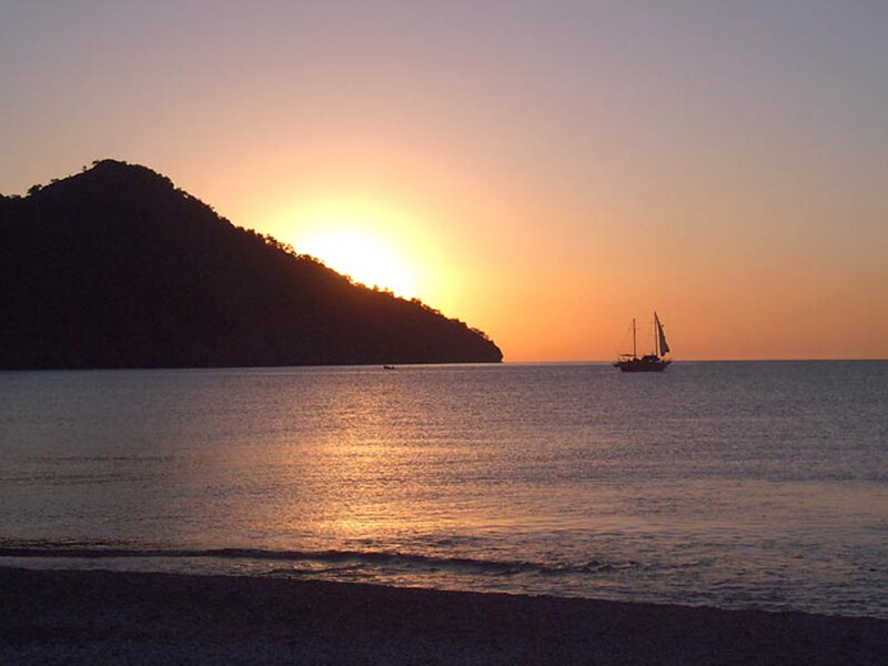 Sunset over the sea with sailboat