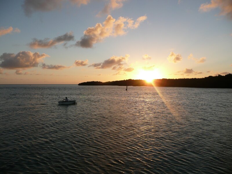 Sunset over the water with a boat