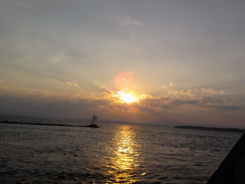 Sunset over the water with a buoy