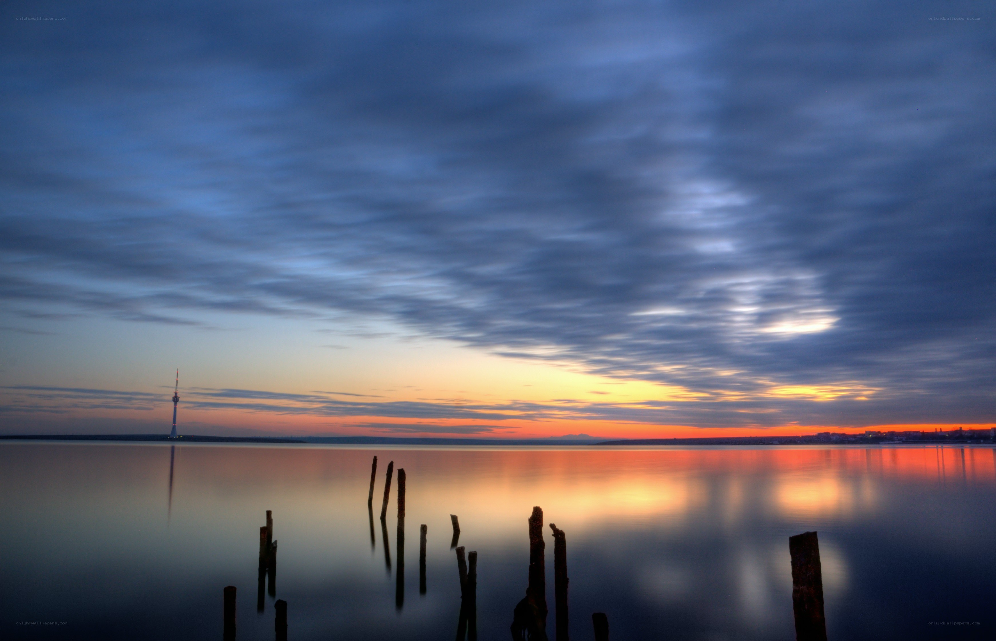 Sunset over the water with tower