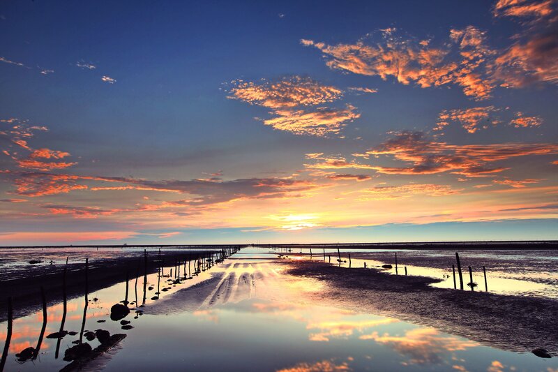 Sunset over Tidal Flats — Blue, Serene, Photograph, Clouds, Water, Sticks, Orange, Yellow