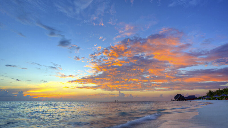 Sunset over Tropical Beach — Blue, Serene, Photograph, Ocean, Clouds, Huts
