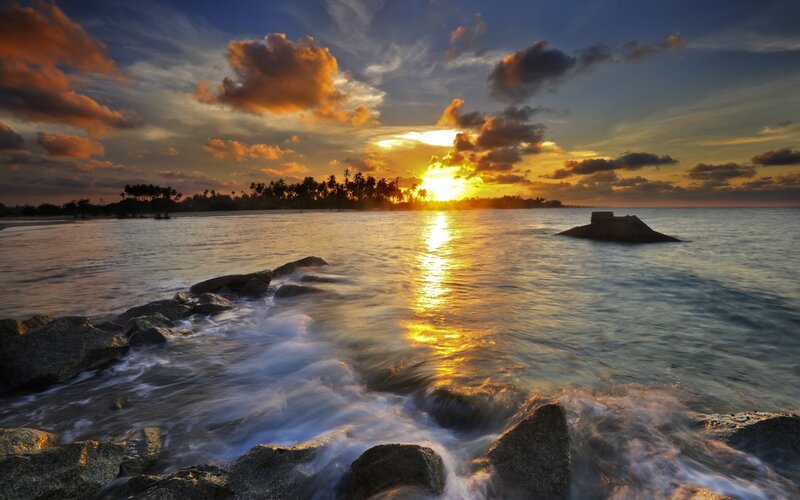 Sunset over Tropical Beach — Orange, Serene, Photograph, Ocean, Rocks, Clouds