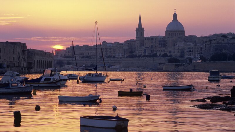 sunset over valletta harbor