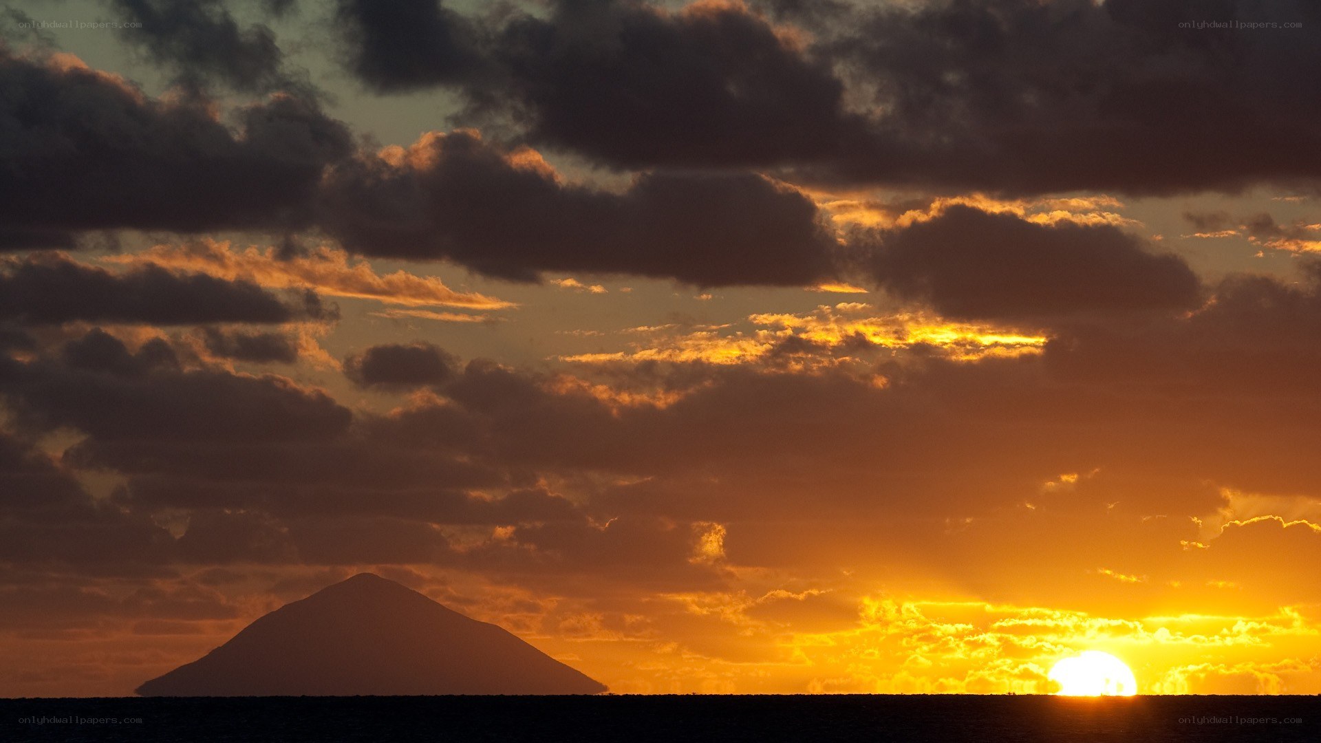 Sunset over volcanic island