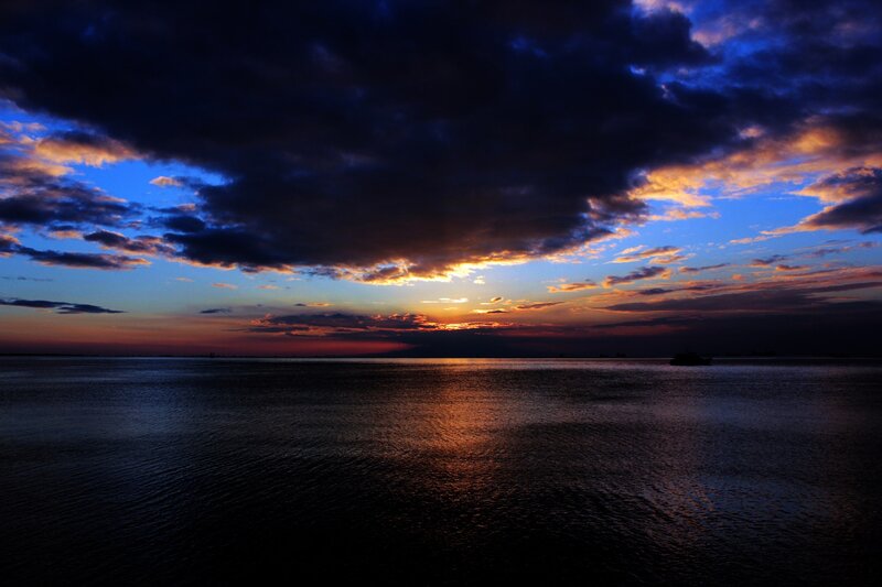 Sunset over Water — Blue, Dramatic, Photograph, Clouds, Sun, Boat