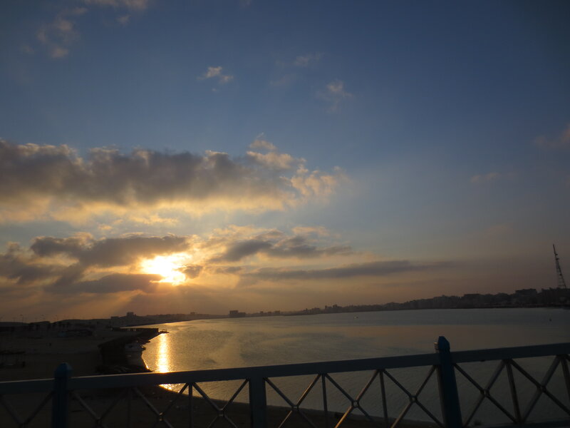 Sunset over Water — Blue, Serene, Photograph, Clouds, Cityscape