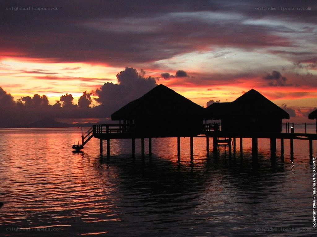 Sunset over water bungalows
