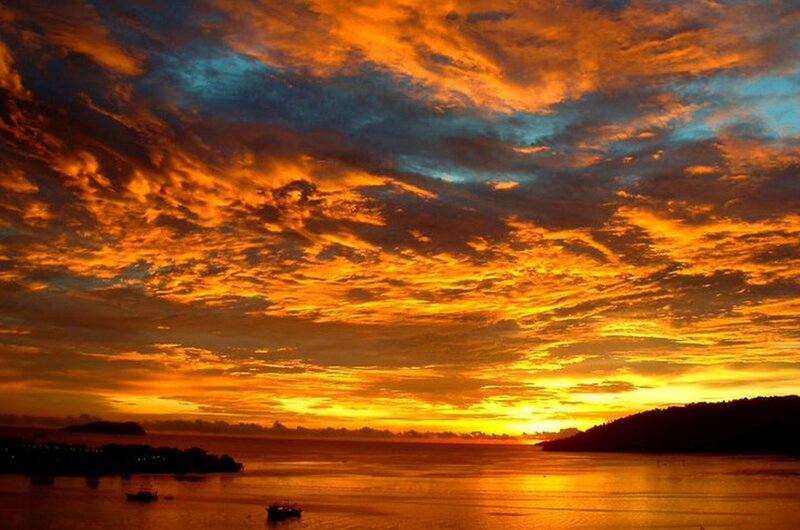 Sunset over Water — Orange, Dramatic, Photograph, Clouds, Boats, Island