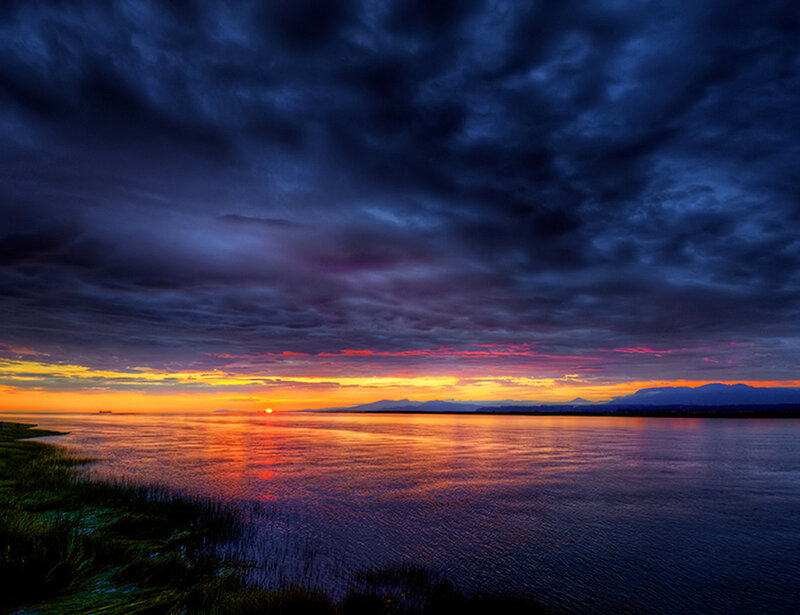 Sunset over Water — Orange, Dramatic, Photograph, Clouds, Mountains, Grass