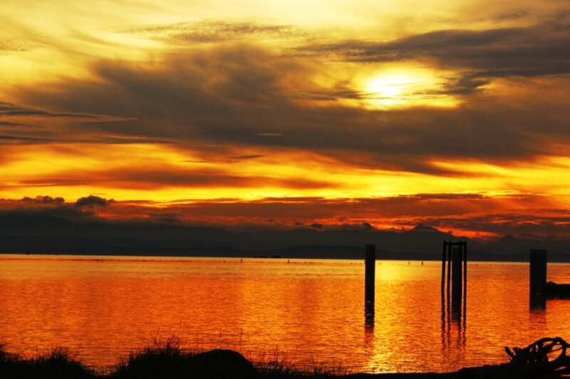 Sunset over Water — Orange, Dramatic, Photograph, Clouds, Mountains, Posts