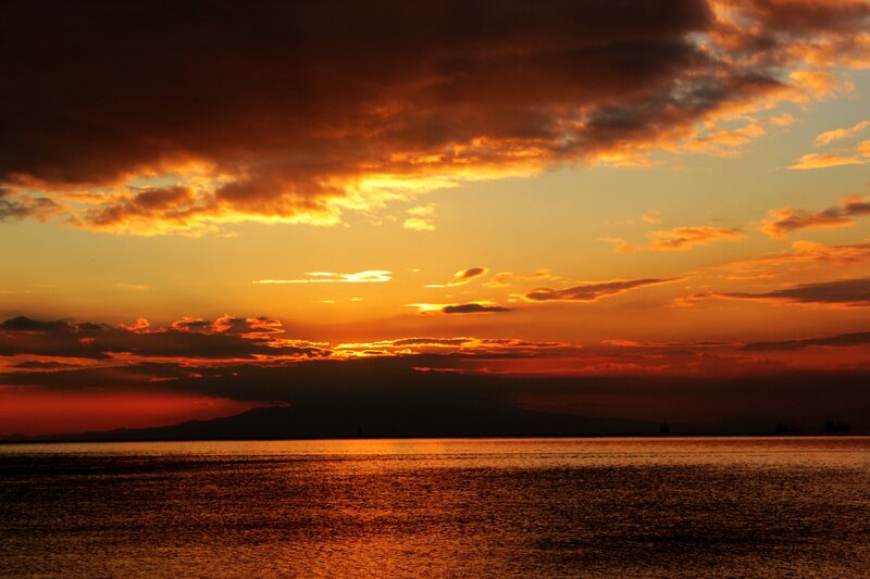 Sunset over Water — Orange, Dramatic, Photograph, Clouds, Mountains, Ship
