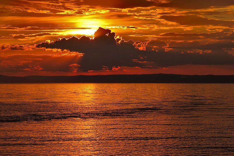 Sunset over Water — Orange, Dramatic, Photograph, Clouds, Mountains, Sun