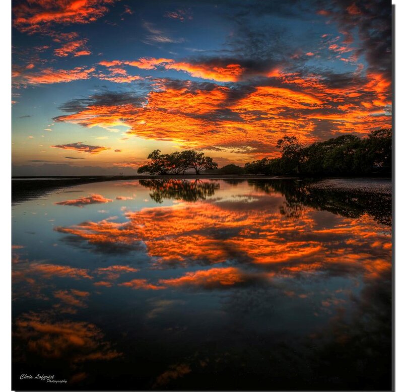 Sunset over Water — Orange, Dramatic, Photograph, Clouds, Trees, Reflection