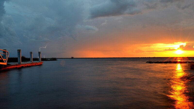 Sunset over Water — Orange, Dramatic, Photograph, Dock, Lightning, Sun