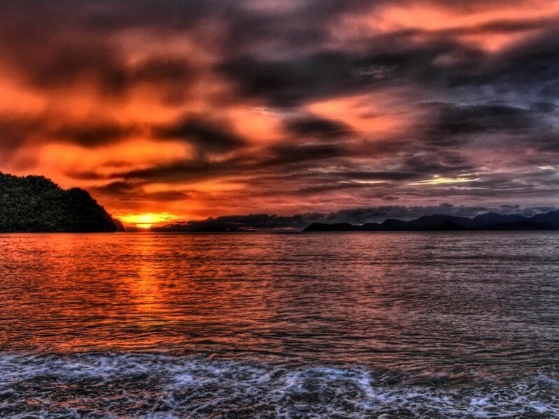 Sunset over Water — Orange, Dramatic, Photograph, Mountains, Clouds