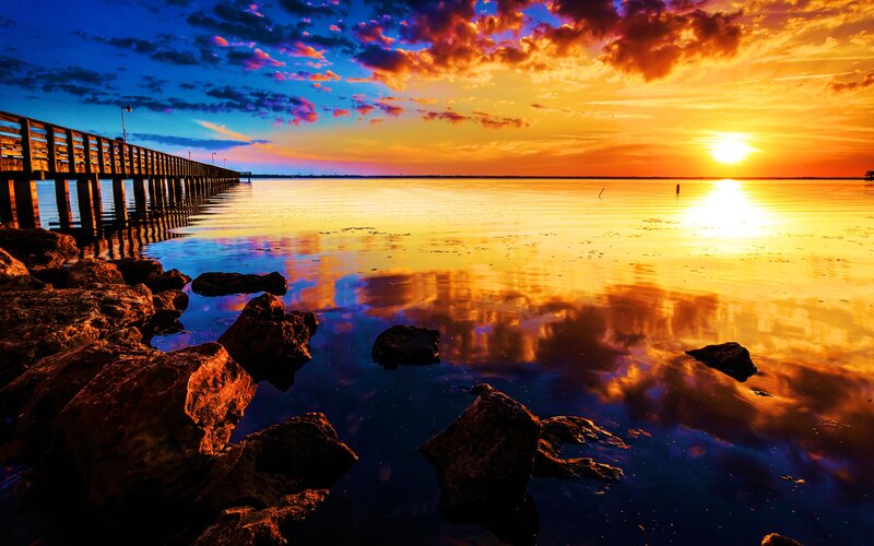 Sunset over Water — Orange, Dramatic, Photograph, Pier, Rocks