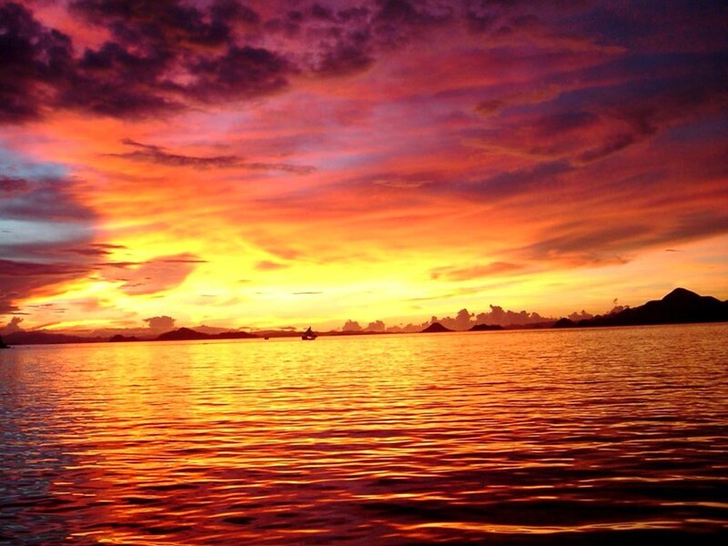 Sunset over Water — Orange, Dramatic, Photograph, Sky, Boat, Islands
