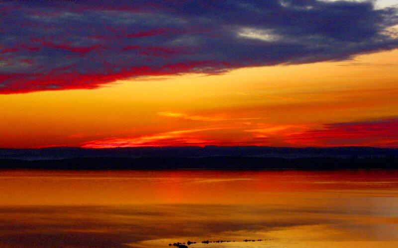 Sunset over Water — Orange, Dramatic, Photograph, Sky, Clouds, Mountains