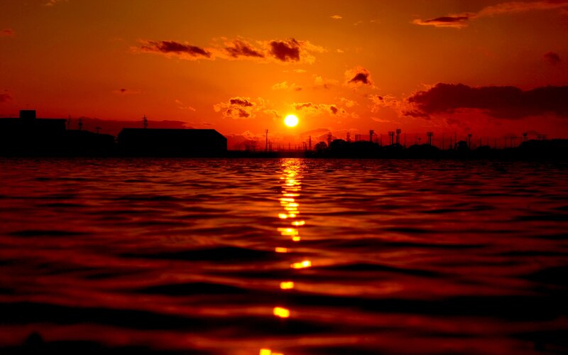 Sunset over Water — Orange, Dramatic, Photograph, Sun, Clouds, Buildings