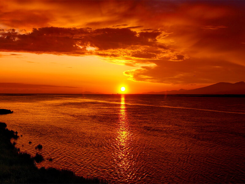Sunset over Water — Orange, Dramatic, Photograph, Sun, Clouds, Mountains