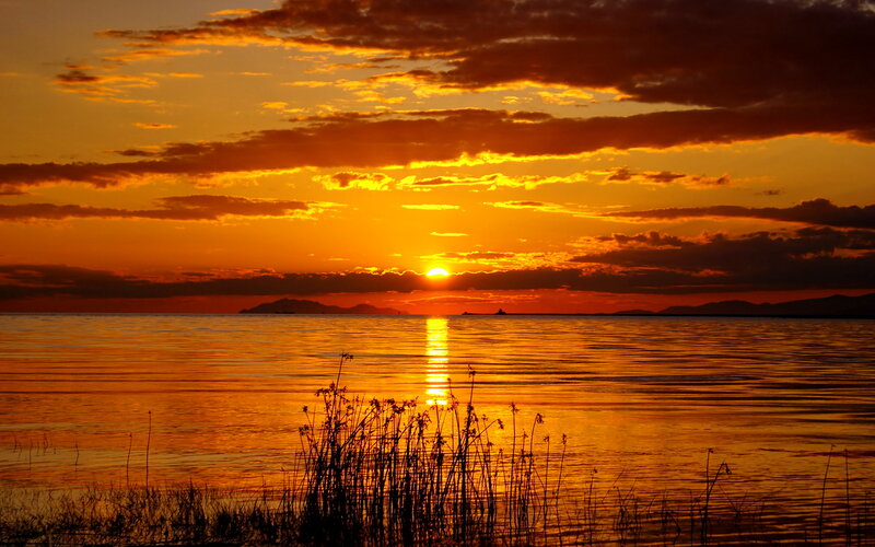 Sunset over Water — Orange, Serene, Photograph, Clouds, Mountains