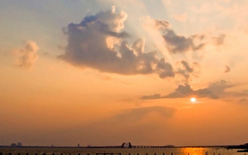 Sunset over Water — Orange, Serene, Photograph, Clouds, Sun, Bridge