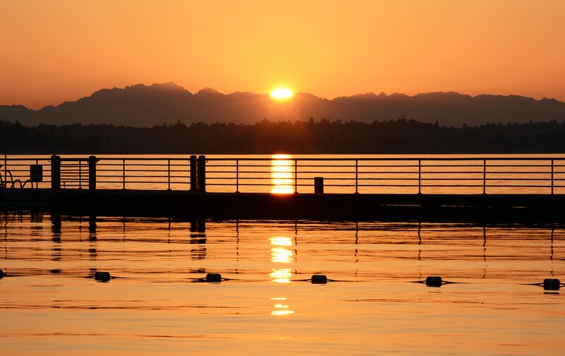Sunset over Water — Orange, Serene, Photograph, Mountains, Dock