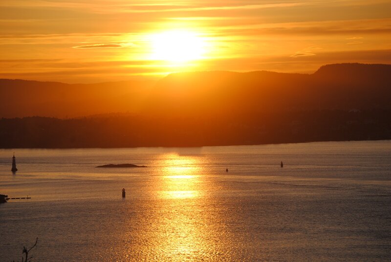 Sunset over Water — Orange, Serene, Photograph, Mountains, Lighthouse