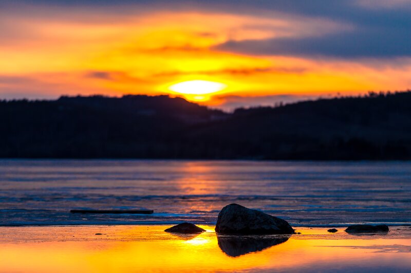 Sunset over Water — Orange, Serene, Photograph, Rocks, Mountains