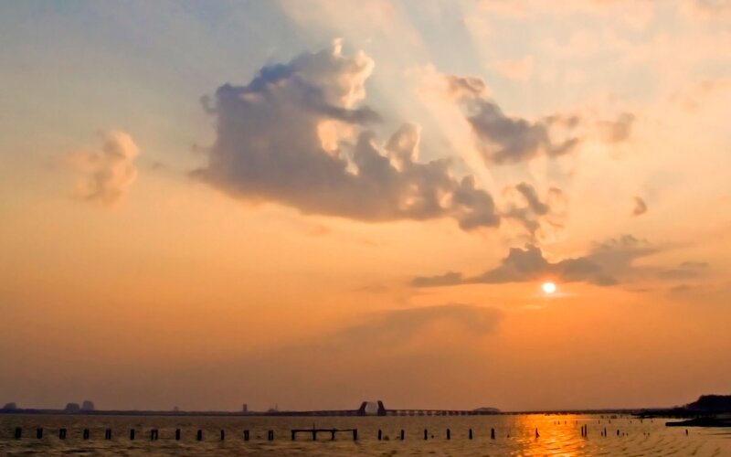 Sunset over Water — Orange, Serene, Photograph, Sun, Clouds, Bridge