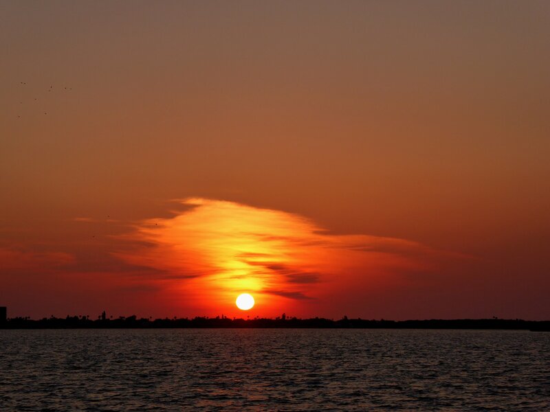 Sunset over Water — Orange, Serene, Photograph, Sun, Clouds, Silhouette