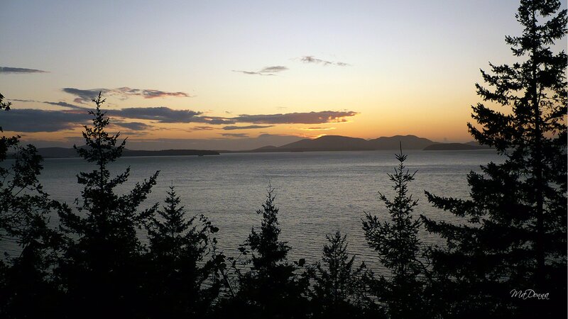 Sunset over Water — Orange, Serene, Photograph, Trees, Mountains, Clouds