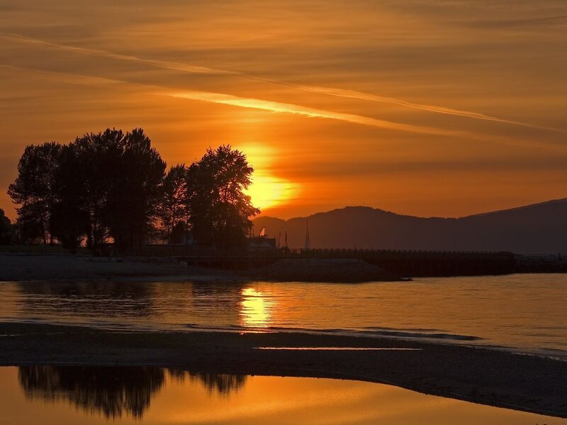 Sunset over Water — Orange, Serene, Photograph, Trees, Mountains, Pier