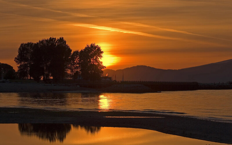 Sunset over Water — Orange, Serene, Photograph, Trees, Mountains