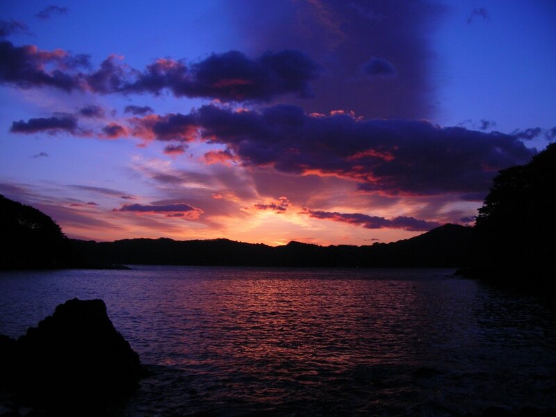 Sunset over Water — Purple, Dramatic, Photograph, Clouds, Mountains, Orange