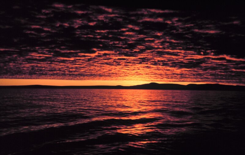 Sunset over Water — Red, Dramatic, Photograph, Clouds, Mountains