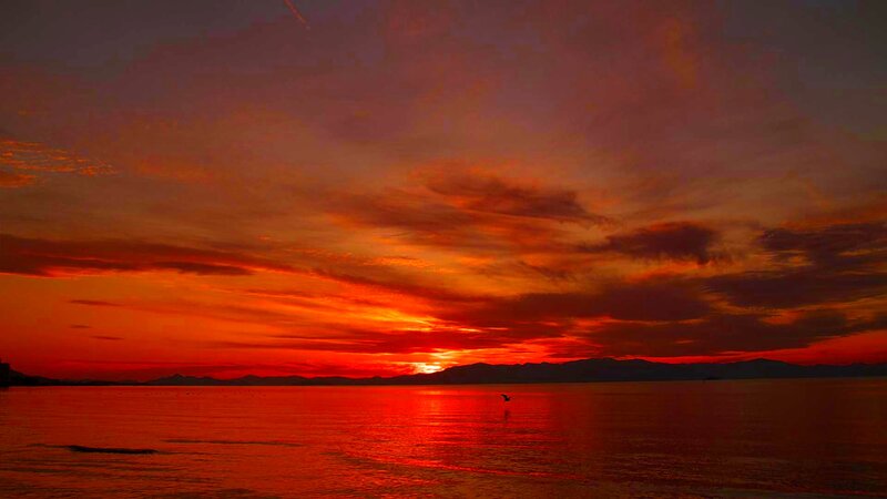 Sunset over Water — Red, Dramatic, Photograph, Mountains
