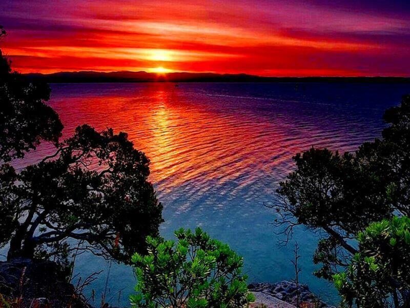 Sunset over Water — Red, Dramatic, Photograph, Trees, Mountains