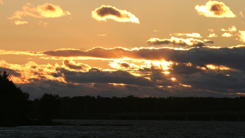 sunset over water with clouds