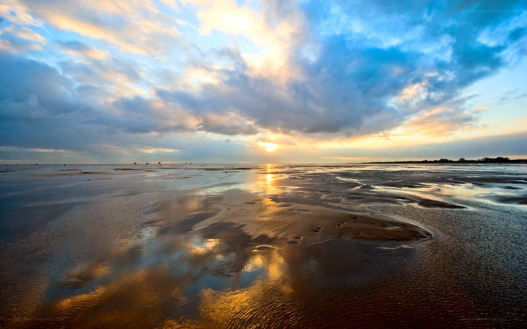 sunset over wet beach