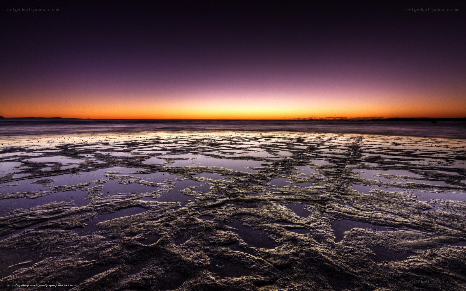 Sunset over wet beach