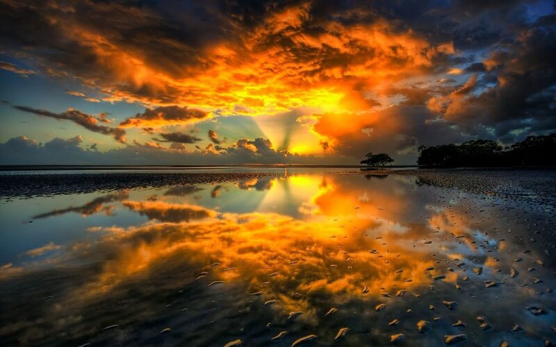 Sunset over wet beach