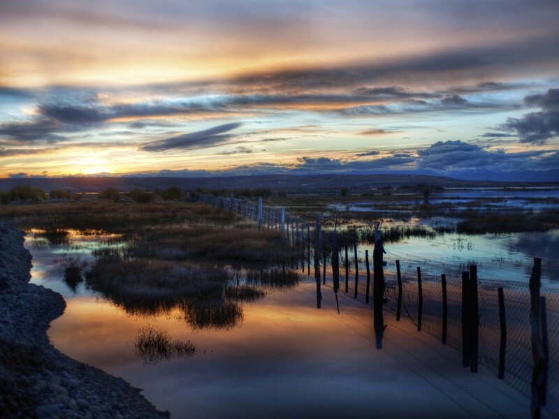 Sunset over Wetlands — Orange, Serene, Photograph, Fence, Marsh, Mountains