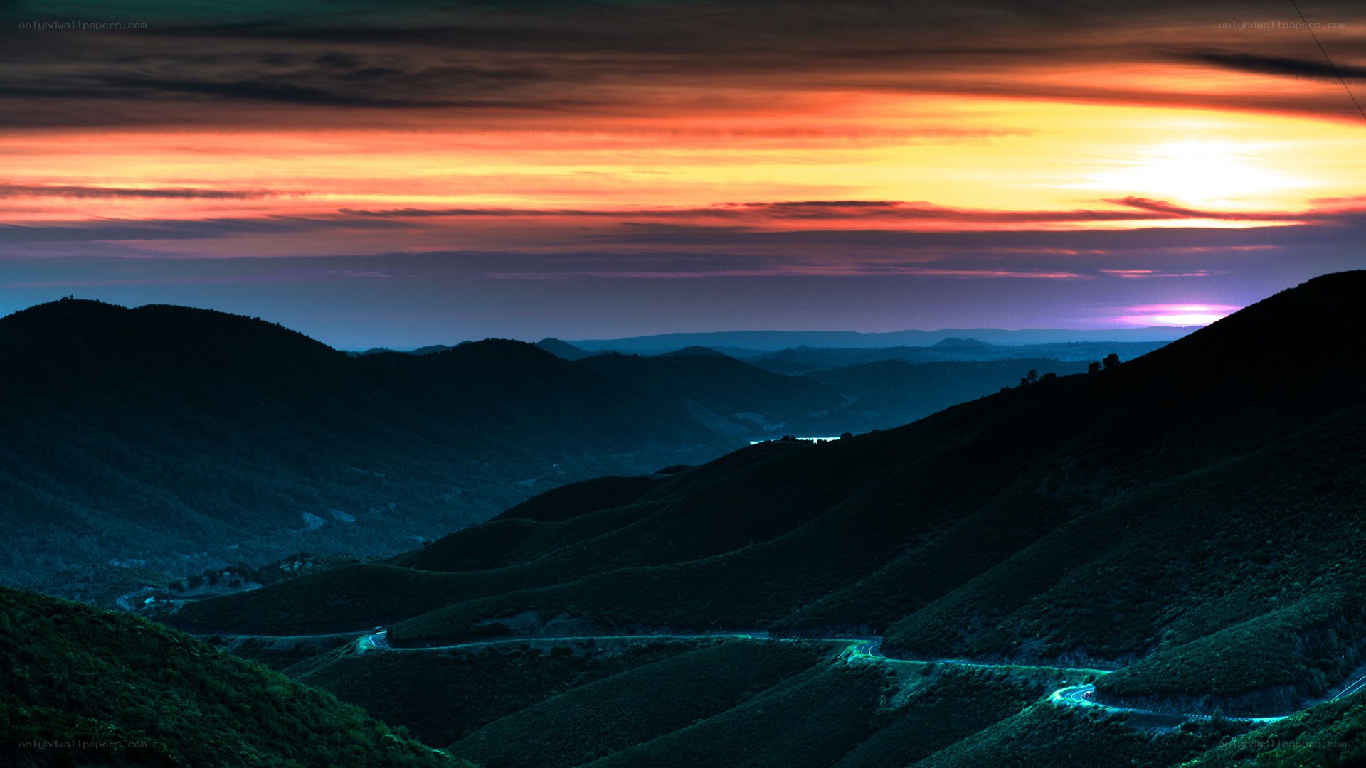 Sunset over winding mountain road