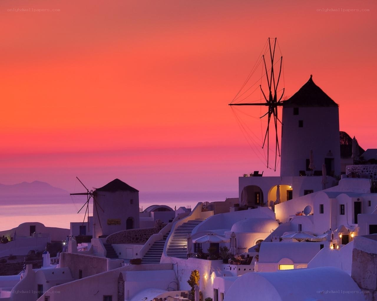 Sunset over windmills in Santorini