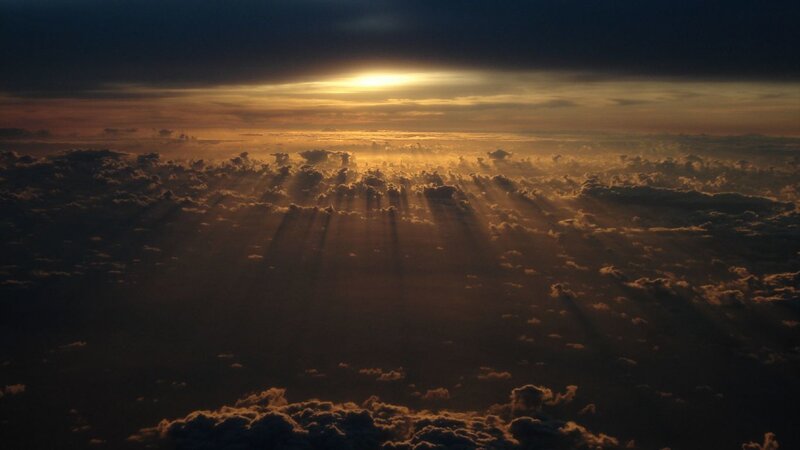 Sunset rays over clouds