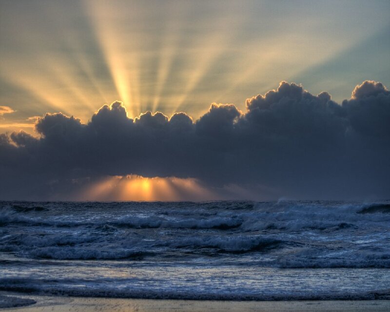 Sunset rays over ocean waves